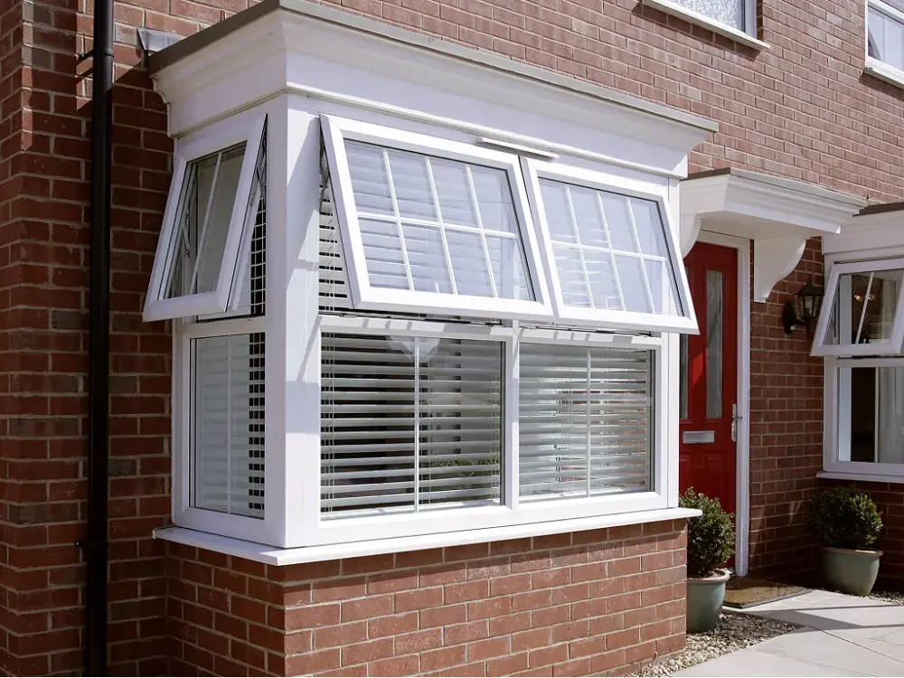 White uPVC casement bay window installed on a brick home